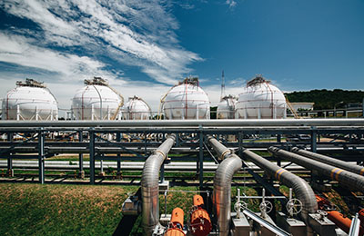 White spherical propane tanks containing fuel gas